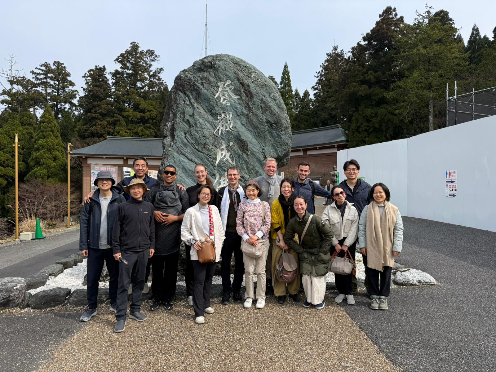 The international retreat group gathered in front of a temple monument near Kyoto.